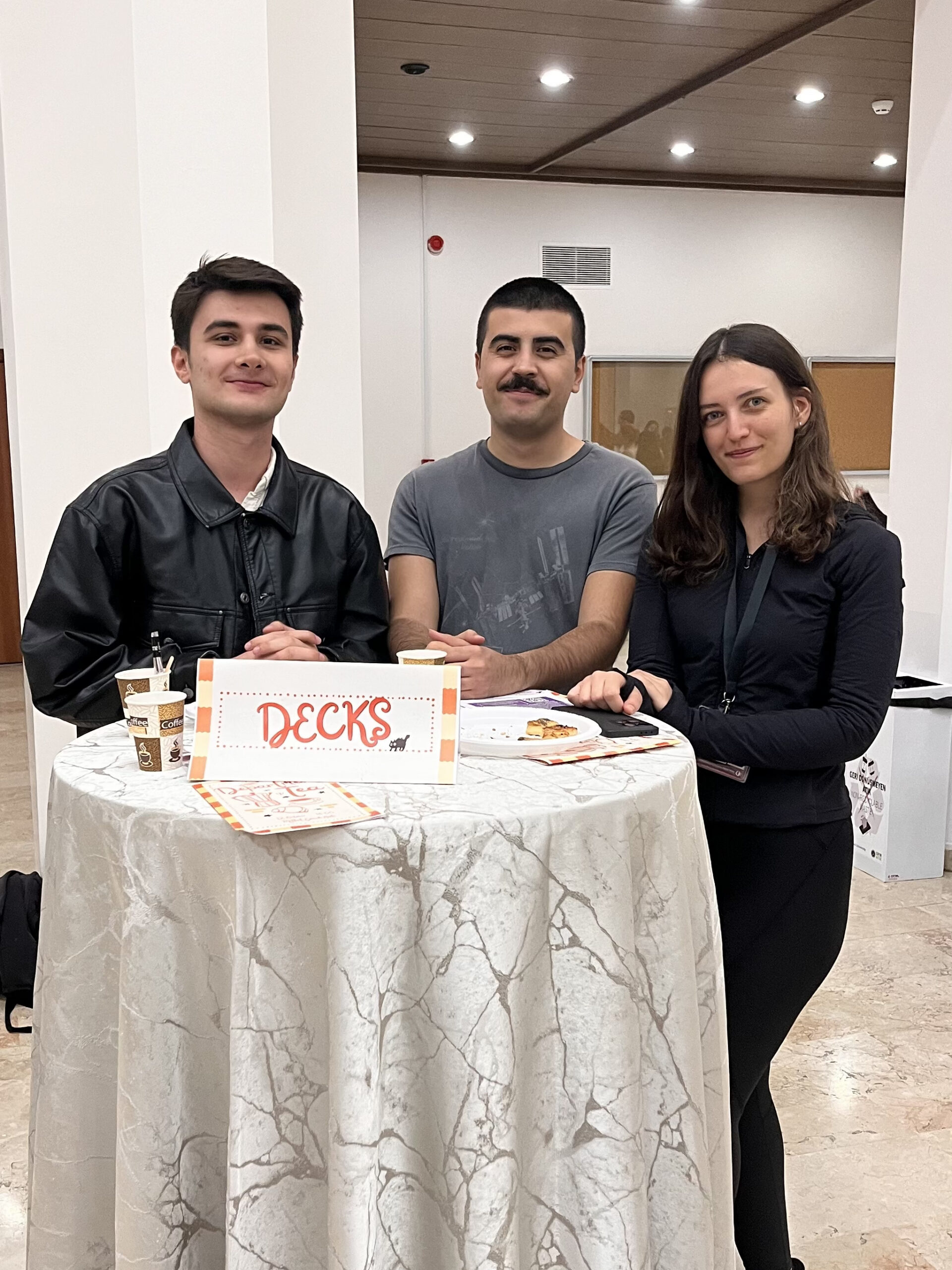 DeCKS Lab members Emre Kurt, Ertaç Yılmaz Beşpınarlı and Ezgi Özgan at the lab table during the Bilkent Psychology Department Tea